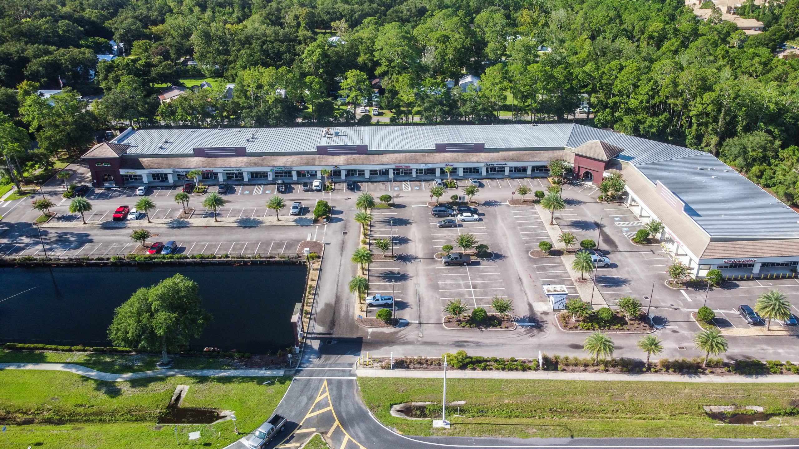 An aerial view of a retail center & parking lot.