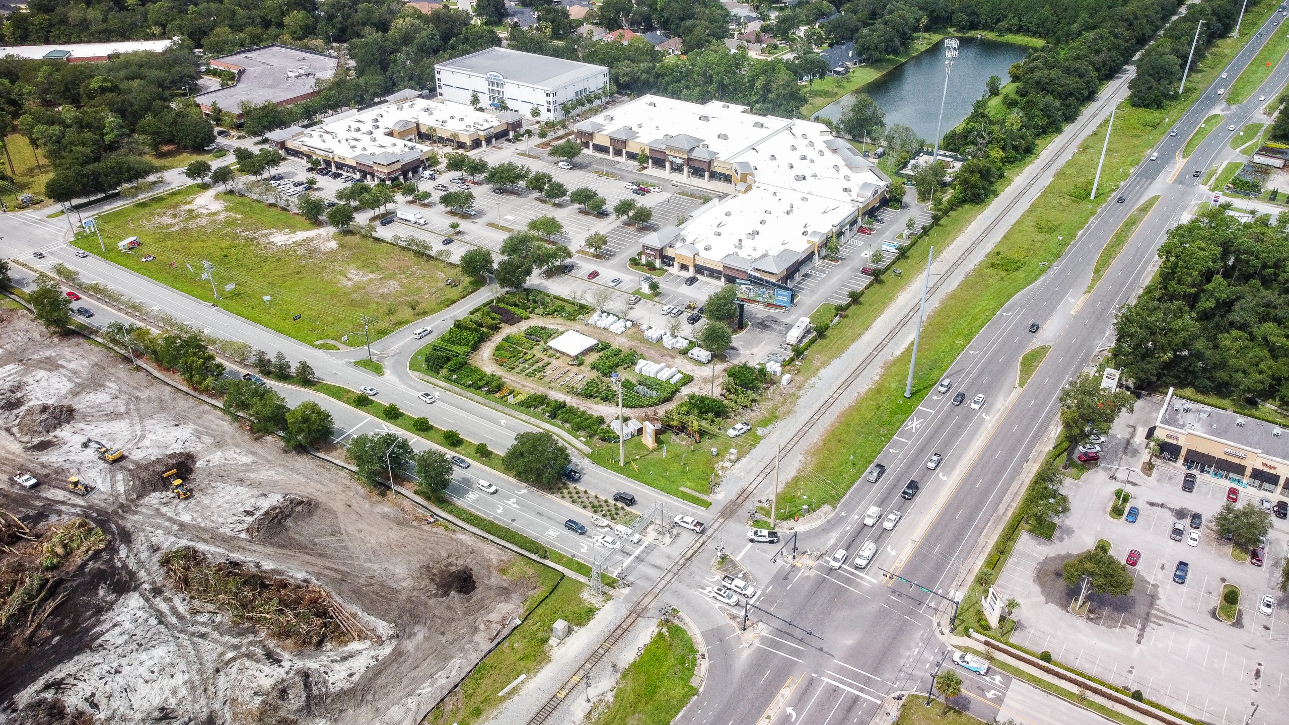 An aerial view of a shopping center and intersection.