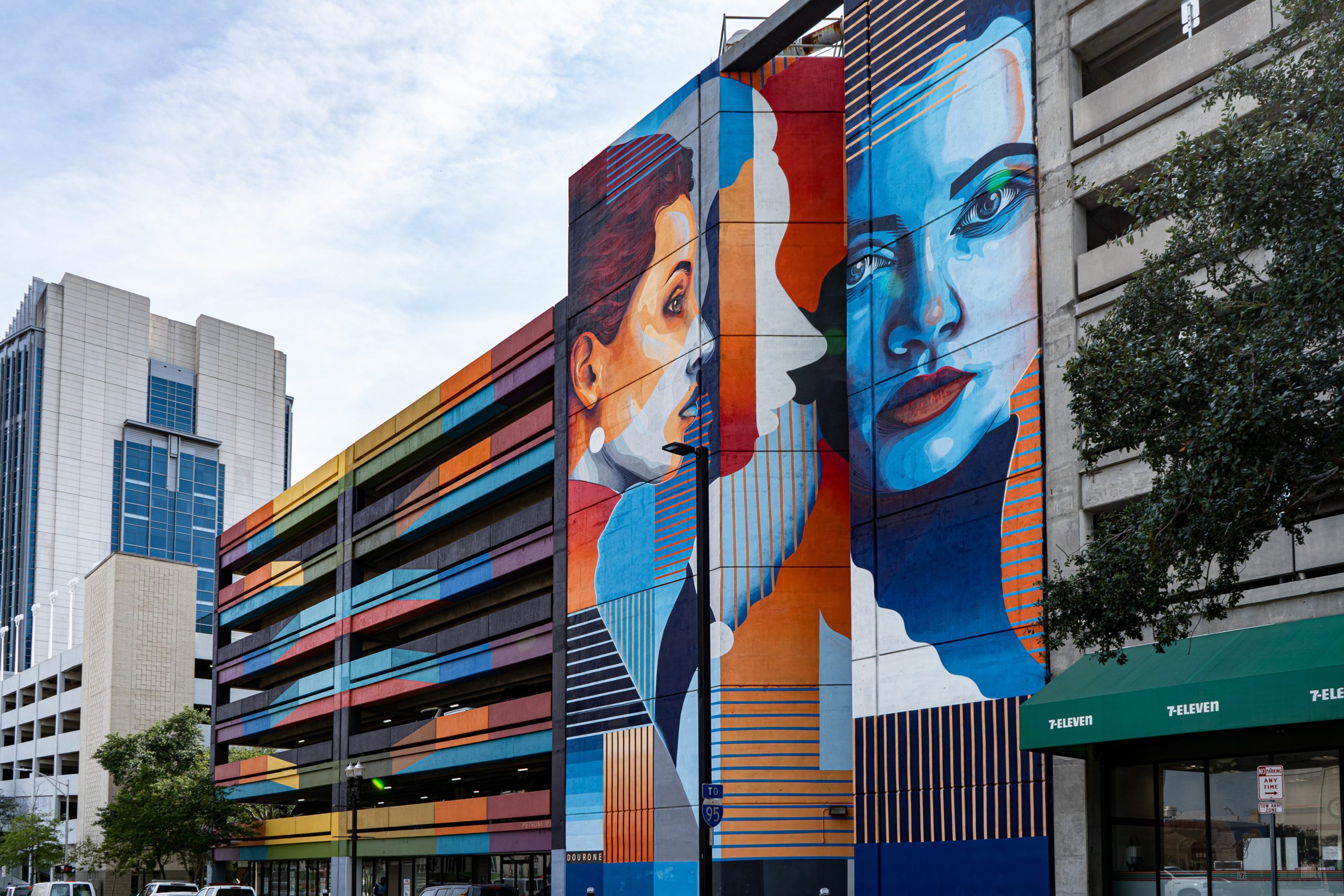 A multi-level parking garage with a painted mural.